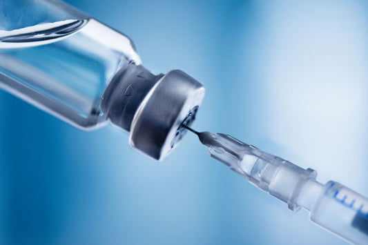 Picture of a needle withdrawing fluid from a vial. Peptide Support